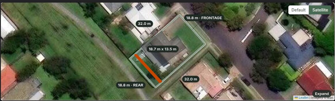 Satellite view of a suburban lot with its cadastral boundary and dimensions overlaid, 18.8 metre frontage and 32 metre depth, and the registered easement marked as an orange strip cutting across the rear corner