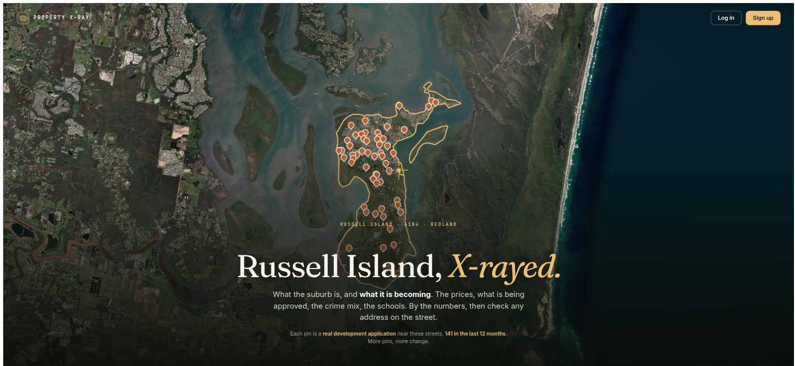 Aerial view of Russell Island on its suburb page at propertyxray.com.au, with the island's boundary traced in gold and orange pins marking 141 development applications lodged near its streets in the last 12 months, surrounded by the waters of southern Moreton Bay.